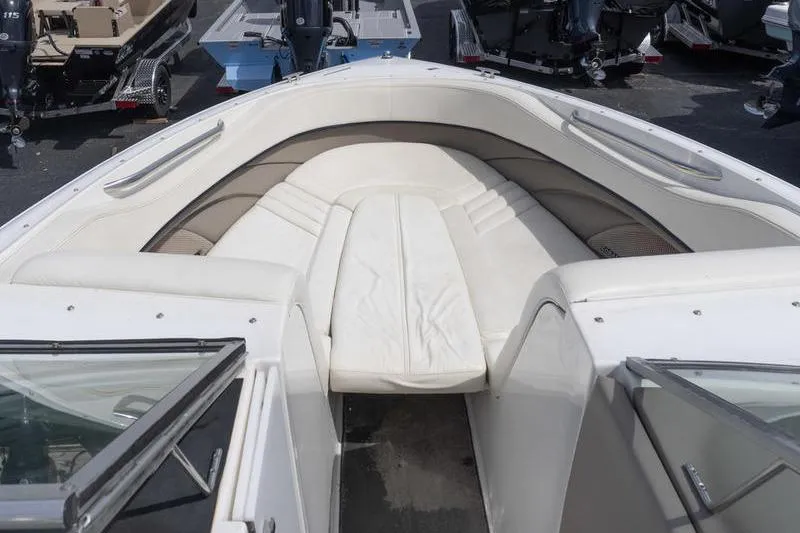 Slide: The Image of 2002 Cobalt 262 boat interior with white cushioned seating and open deck view. - 10