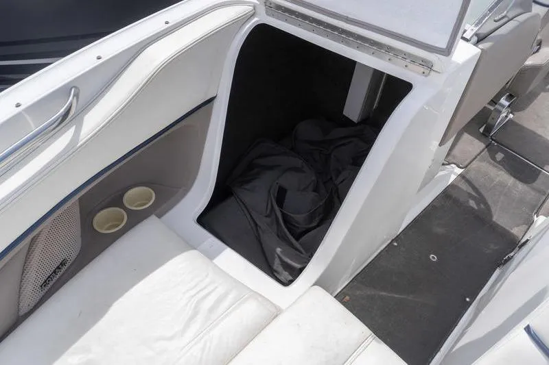 Slide: The Image of Interior of a 2002 Cobalt 262 boat showing storage compartment and seating area. - 11