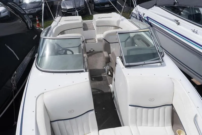 Slide: The Image of 2002 Cobalt 262 boat interior with white seating and open cockpit design. - 12