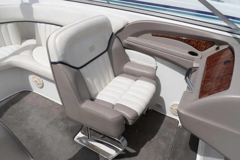Slide: The Image of Interior of a 2002 Cobalt 262 boat featuring plush seating and elegant wood accents. - 15