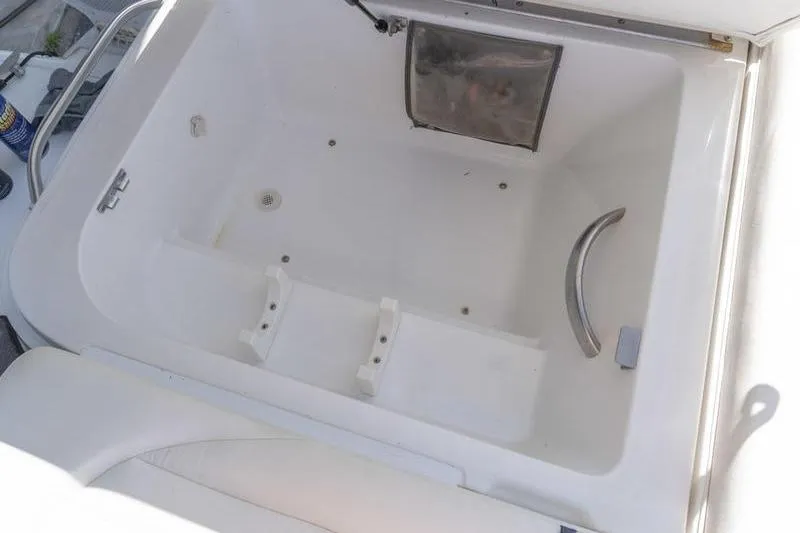 Slide: The Image of Open storage compartment in a 2002 Cobalt 262 boat, featuring a clean white interior. - 20