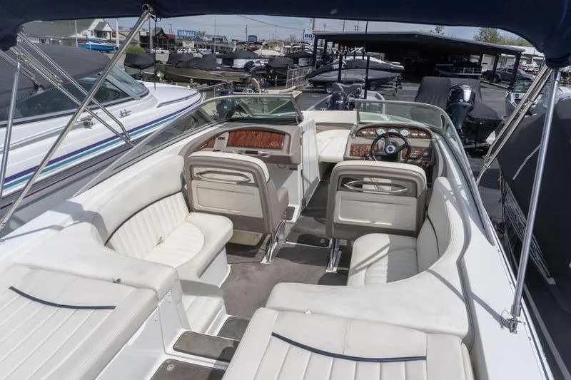 Slide: The Image of Interior of a 2002 Cobalt 262 boat with white seating and dashboard. - 5