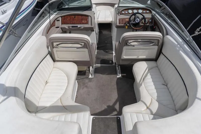 Slide: The Image of Interior of a 2002 Cobalt 262 boat with white seating and dashboard. - 7