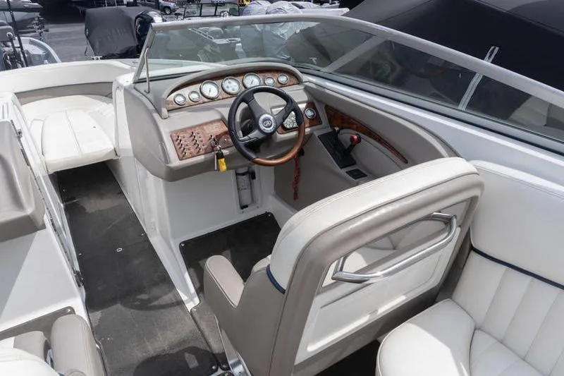 Slide: The Image of Interior of a 2002 Cobalt 262 boat, featuring a sleek dashboard and comfortable seating. - 9