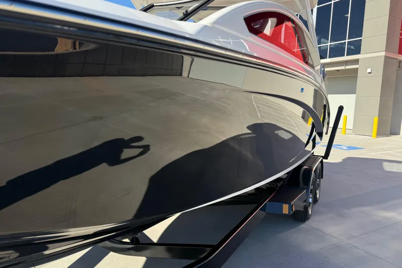 Slide: The Image of 2024 Yamaha Boats 275SD on trailer, sleek black hull, modern design. - 11