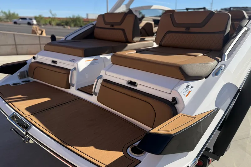 Slide: The Image of 2024 Yamaha Boats 275SD with luxurious brown seating and sleek design. - 13
