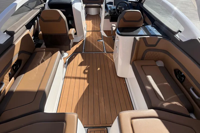 Slide: The Image of 2024 Yamaha Boats 275SD interior with luxurious brown seating and sleek design. - 20