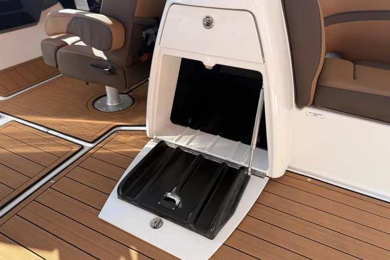 Slide: The Image of 2024 Yamaha Boats 275SD interior with open storage compartment and brown seating. - 22