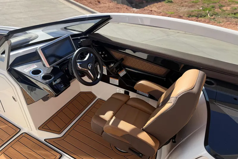 Slide: The Image of 2024 Yamaha Boats 275SD cockpit with modern steering and luxurious seating. - 24
