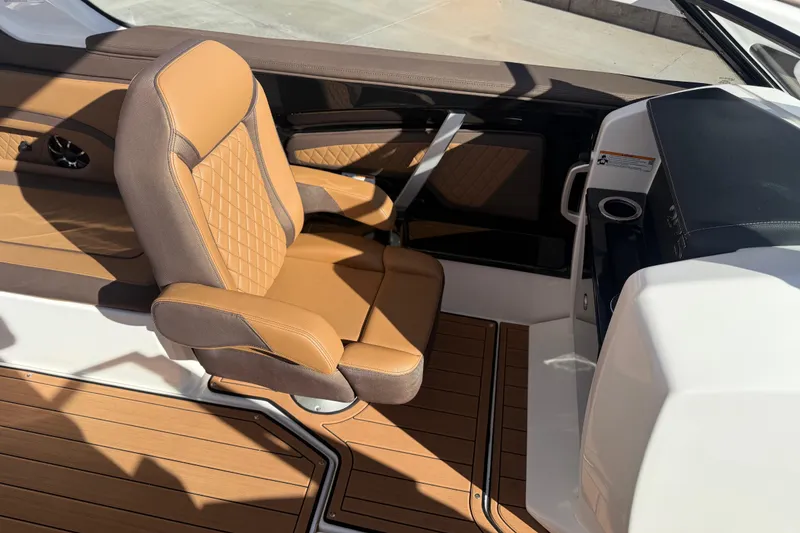 Slide: The Image of 2024 Yamaha Boats 275SD interior with tan leather seating and sleek design. - 26
