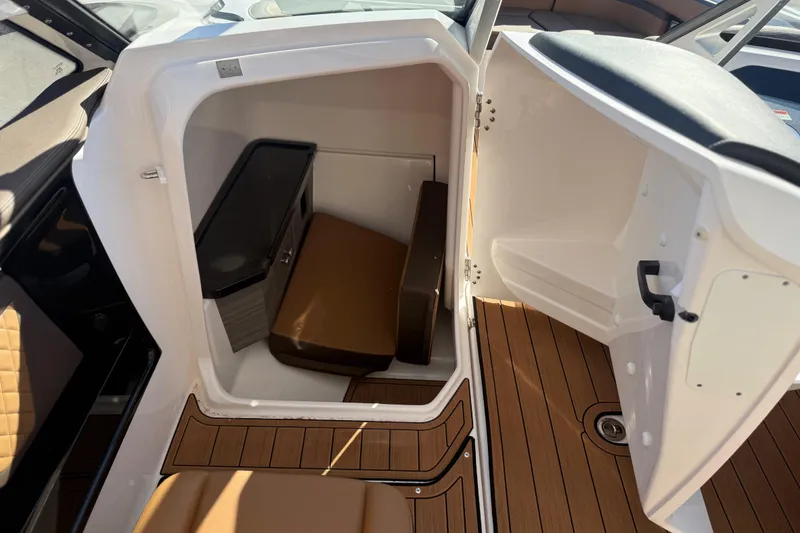Slide: The Image of 2024 Yamaha Boats 275SD interior cabin with seating and storage. - 27