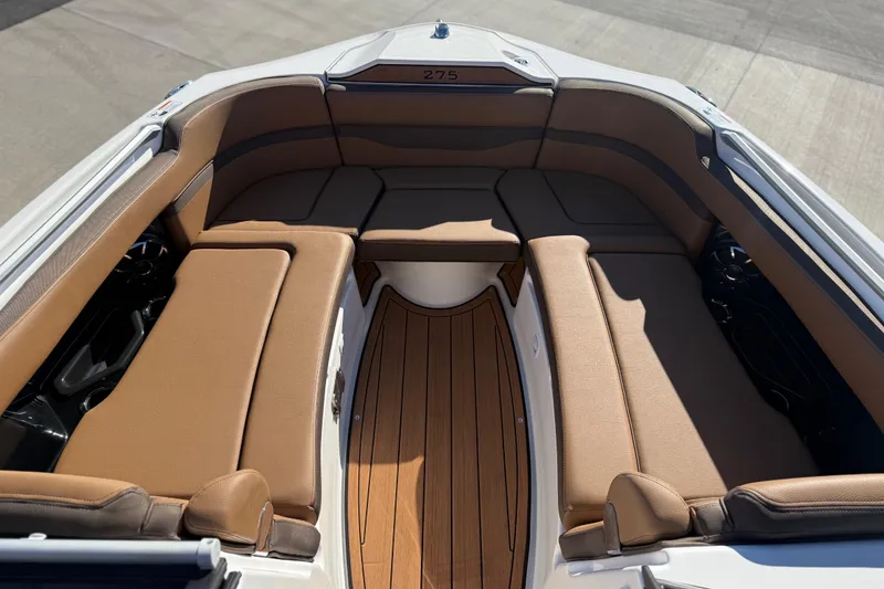 Slide: The Image of 2024 Yamaha Boats 275SD interior with tan seating and wood flooring. - 29