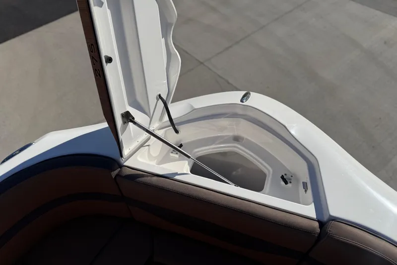Slide: The Image of 2024 Yamaha Boats 275SD storage compartment with open hatch, showcasing interior design. - 30