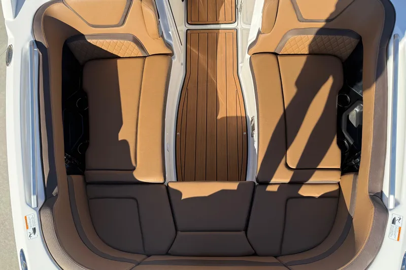 Slide: The Image of 2024 Yamaha Boats 275SD interior with brown leather seating and wood flooring. - 31