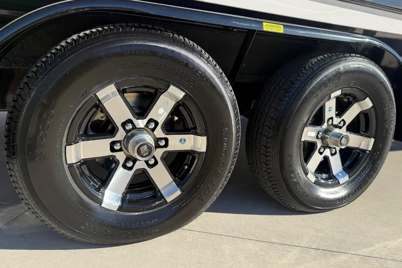 Slide: The Image of 2024 Yamaha Boats 275SD trailer wheels, featuring sleek black and silver rims. - 41
