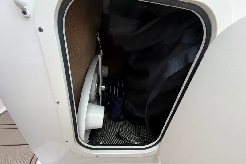 Slide: The Image of Storage compartment inside a 2021 Chaparral 23 SSi boat, featuring interior details. - 13