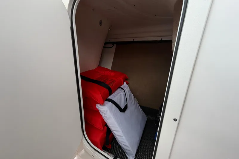 Slide: The Image of Storage compartment in 2021 Chaparral 23 SSi boat with life jackets. - 14