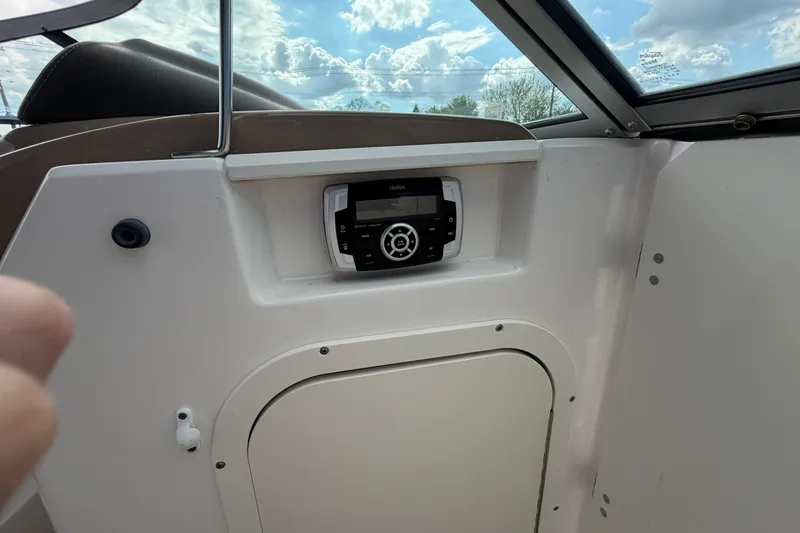 Slide: The Image of 2021 Chaparral 23 SSi boat interior with stereo system and storage compartment. - 15