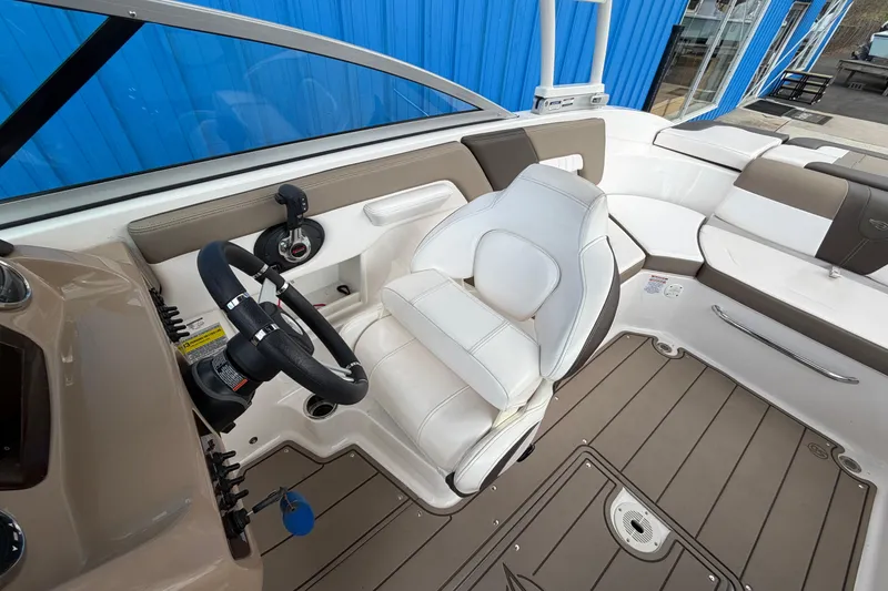 Slide: The Image of 2021 Chaparral 23 SSi boat interior with steering wheel and seating. - 17
