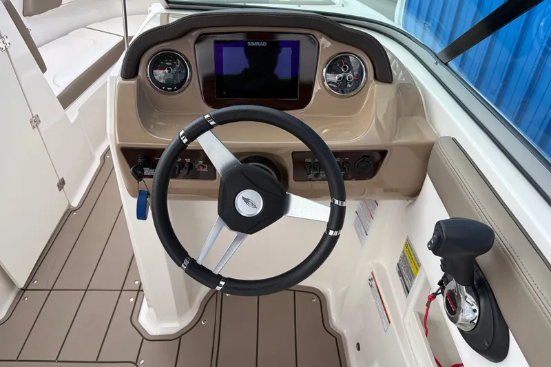 Slide: The Image of 2021 Chaparral 23 SSi boat dashboard with steering wheel and control panel. - 20