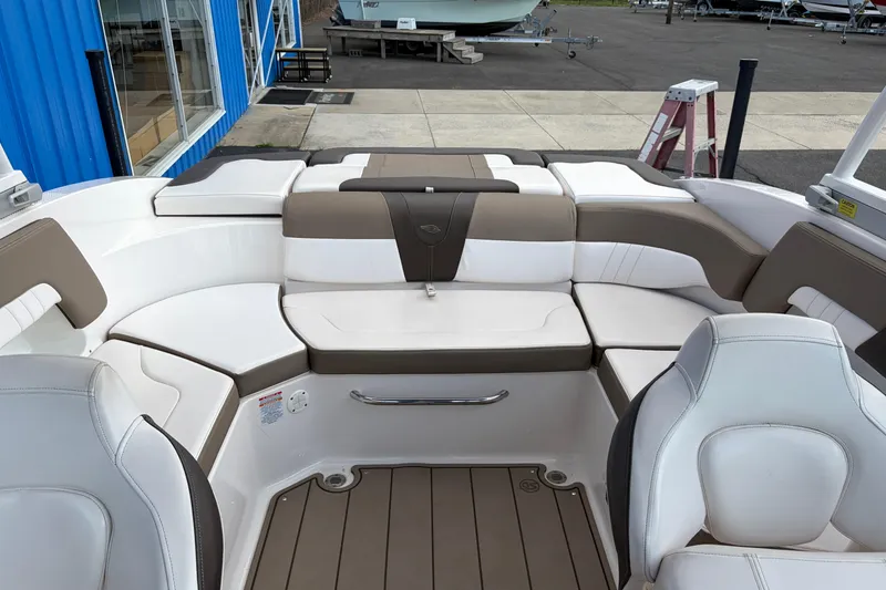 Slide: The Image of 2021 Chaparral 23 SSi boat interior with white and brown seating. - 22