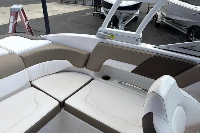 Slide: The Image of 2021 Chaparral 23 SSi boat interior with beige and white seating. - 23