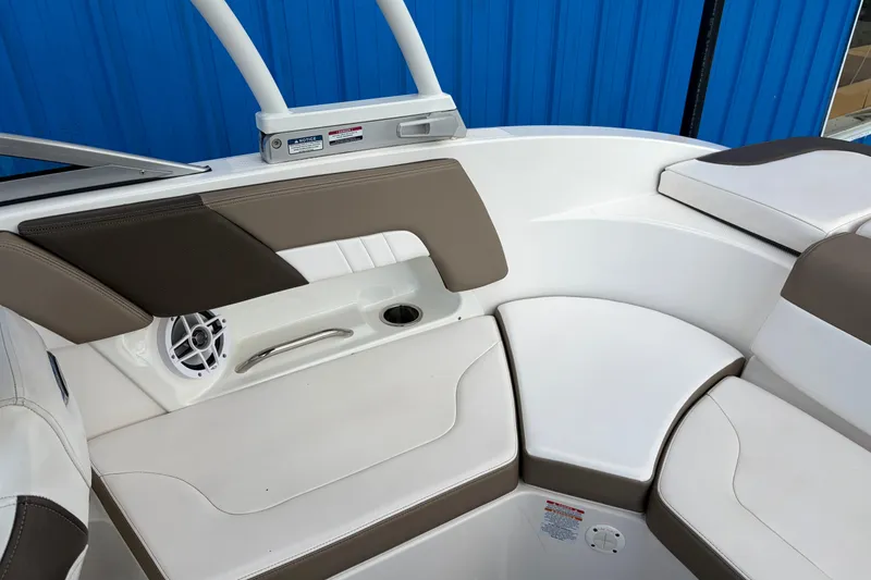 Slide: The Image of Interior seating of 2021 Chaparral 23 SSi boat with white and brown upholstery. - 24