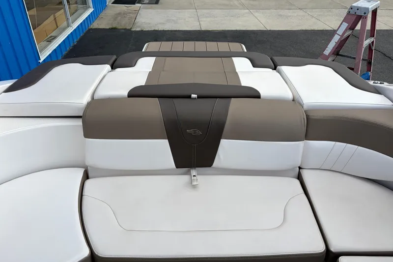 Slide: The Image of 2021 Chaparral 23 SSi boat interior with beige and white cushioned seating. - 25