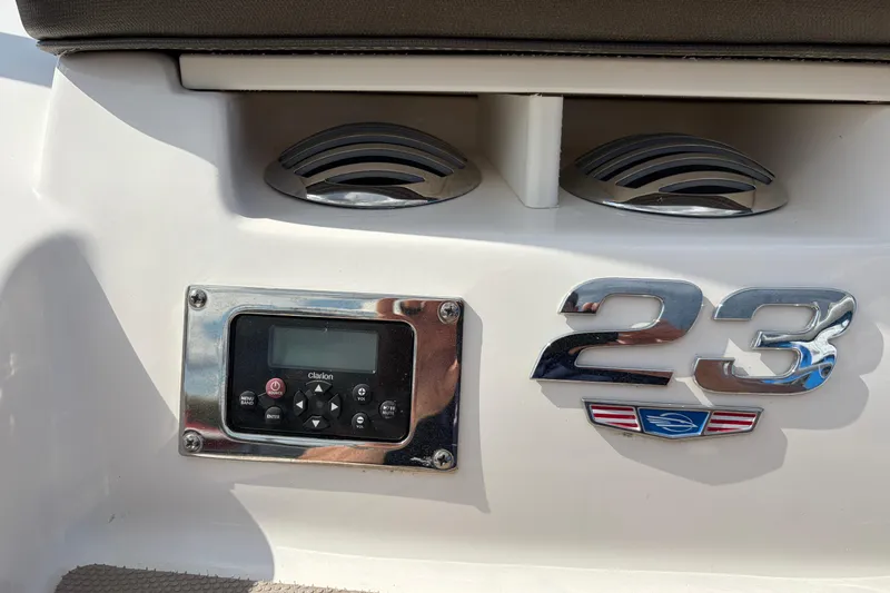 Slide: The Image of 2021 Chaparral 23 SSi boat dashboard with Clarion audio system and chrome model emblem. - 31