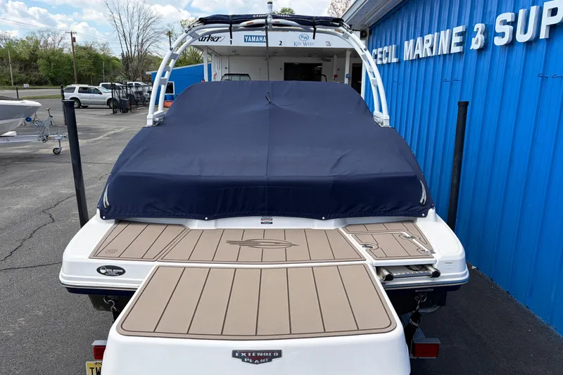 Slide: The Image of 2021 Chaparral 23 SSi boat with blue cover at marine supply store. - 5