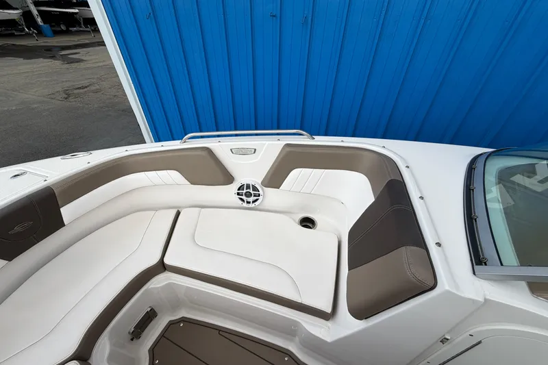 Slide: The Image of 2021 Chaparral 23 SSi boat interior with white and brown seating. - 9