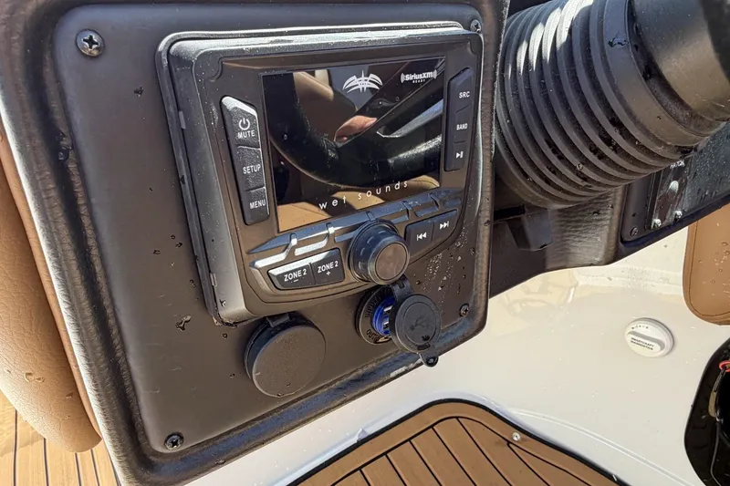 Slide: The Image of 2024 Crownline 260 SS boat dashboard with audio control panel. - 4