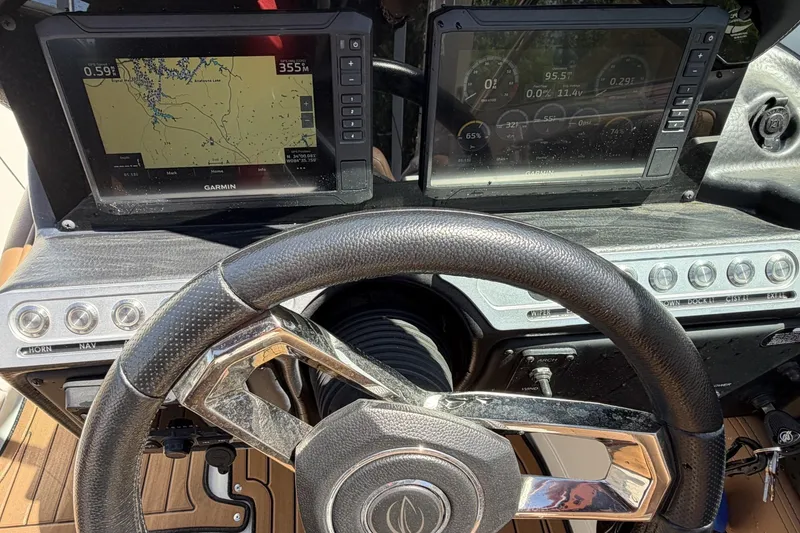Slide: The Image of 2024 Crownline 260 SS dashboard with Garmin navigation displays and steering wheel. - 5