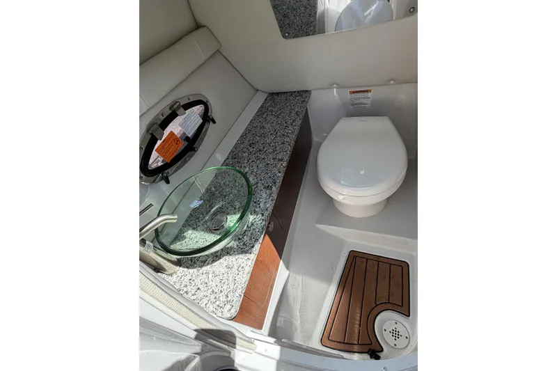 Slide: The Image of 2024 Crownline 260 SS boat bathroom with modern sink and toilet. - 6