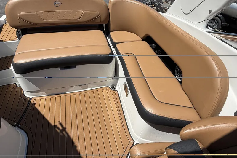 Slide: The Image of 2024 Crownline 260 SS boat interior with tan leather seating and teak flooring. - 7