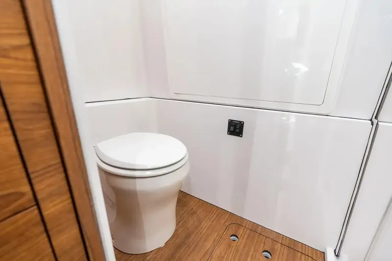 Slide: The Image of Manufacturer Provided Image: 2026 Sportsman Open 402 Center Console boat interior with modern toilet and wood flooring. - 10