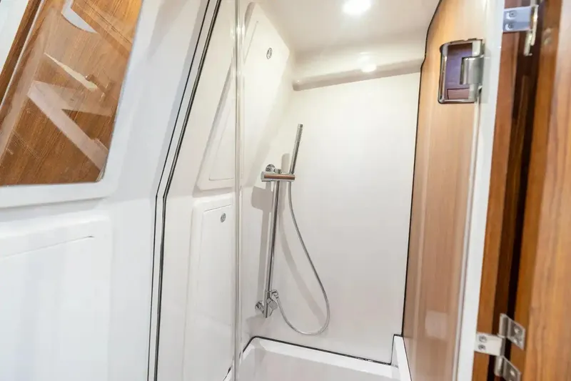 Slide: The Image of Manufacturer Provided Image: 2026 Sportsman Open 402 Center Console boat interior shower area with modern fixtures. - 11