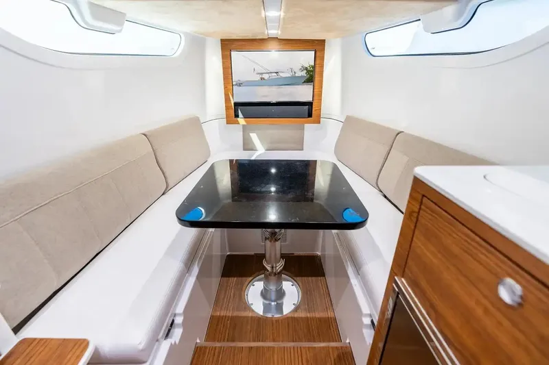 Slide: The Image of Manufacturer Provided Image: Interior of 2026 Sportsman Open 402 Center Console with seating and table. - 8