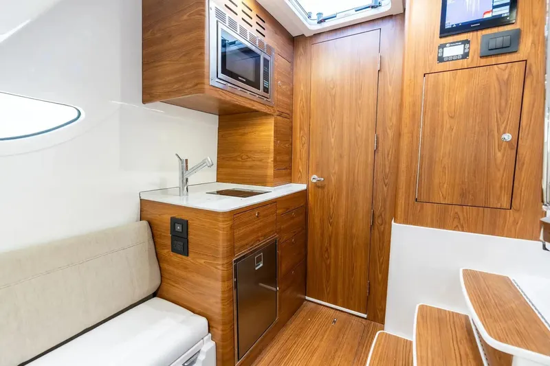 Slide: The Image of Manufacturer Provided Image: Luxurious interior of 2026 Sportsman Open 402 Center Console with wood finish and modern amenities. - 9