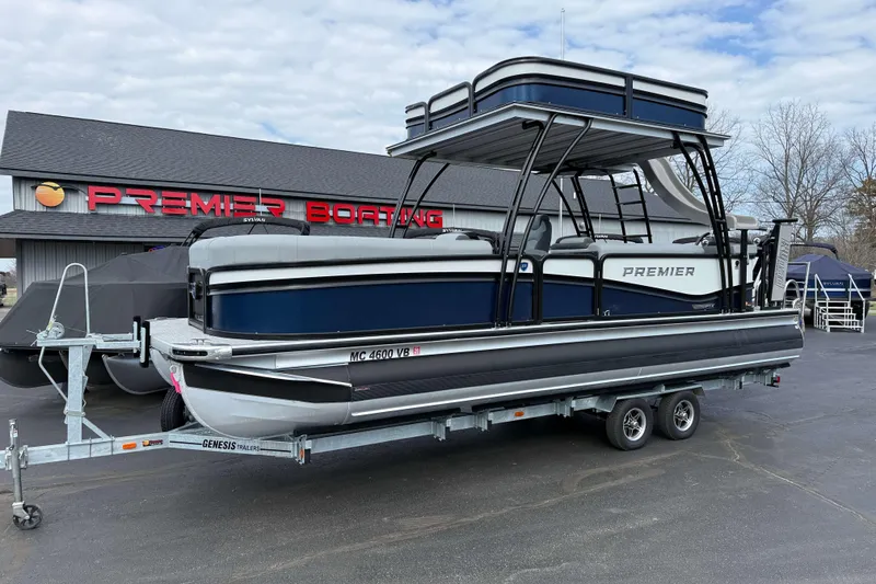 The Image of 2025 Premier 250 Solaris Upper Deck pontoon boat on trailer at Premier Boating dealership. - 0