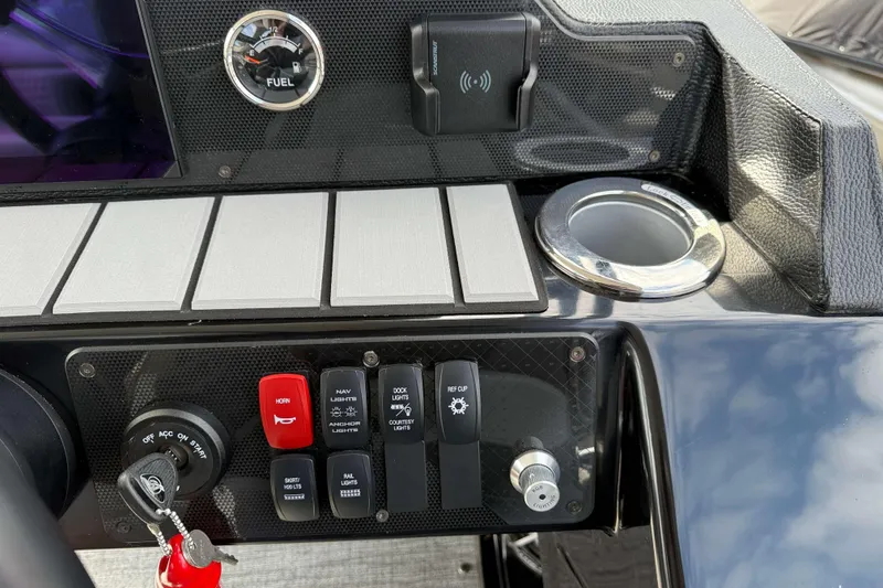 Slide: The Image of Control panel of 2025 Premier 250 Solaris Upper Deck - CL with switches and fuel gauge. - 13