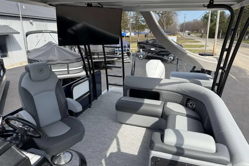 Slide: The Image of Luxurious 2025 Premier 250 Solaris Upper Deck - CL boat interior with seating and entertainment features. - 17