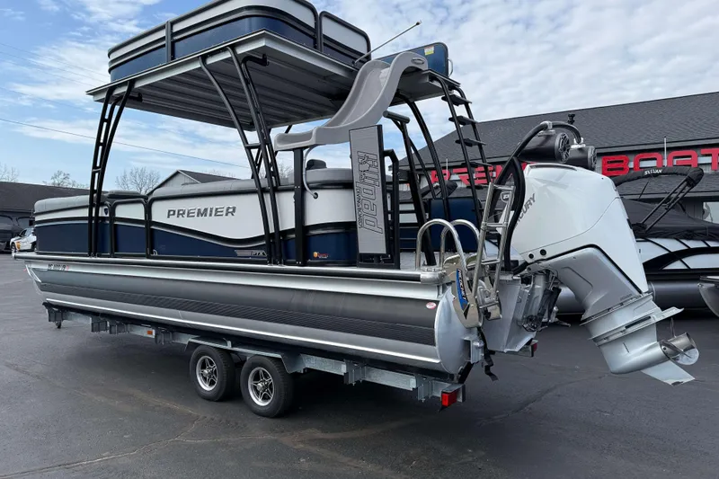 Slide: The Image of 2025 Premier 250 Solaris Upper Deck pontoon boat with Mercury outboard motor on trailer. - 4