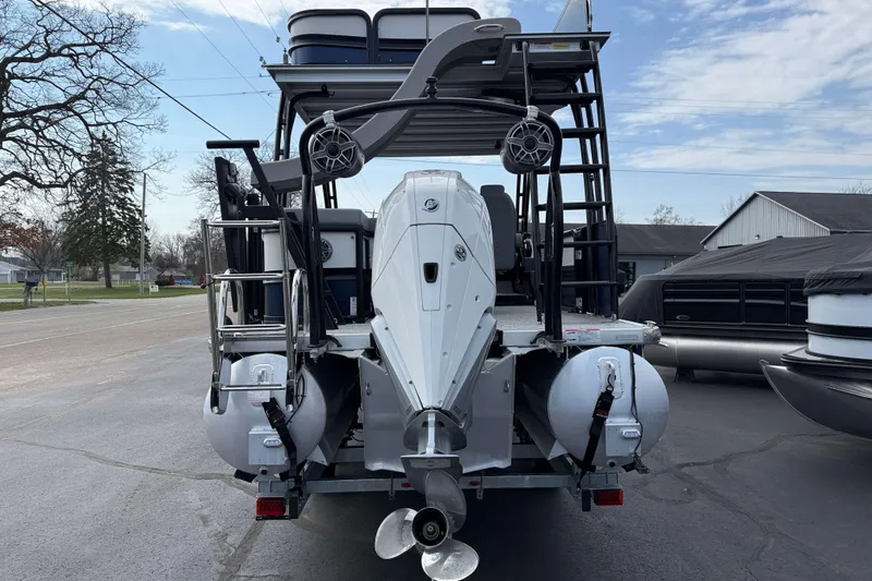 Slide: The Image of 2025 Premier 250 Solaris Upper Deck - CL pontoon boat, rear view with motor and ladder. - 5