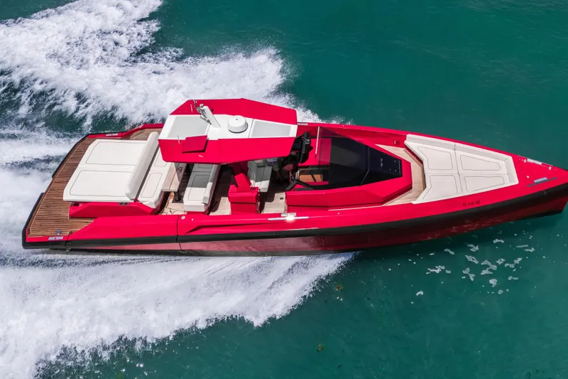 Slide: The Image of Red 2021 Wally 48 yacht cruising on turquoise water, showcasing sleek design and luxury features. - 11