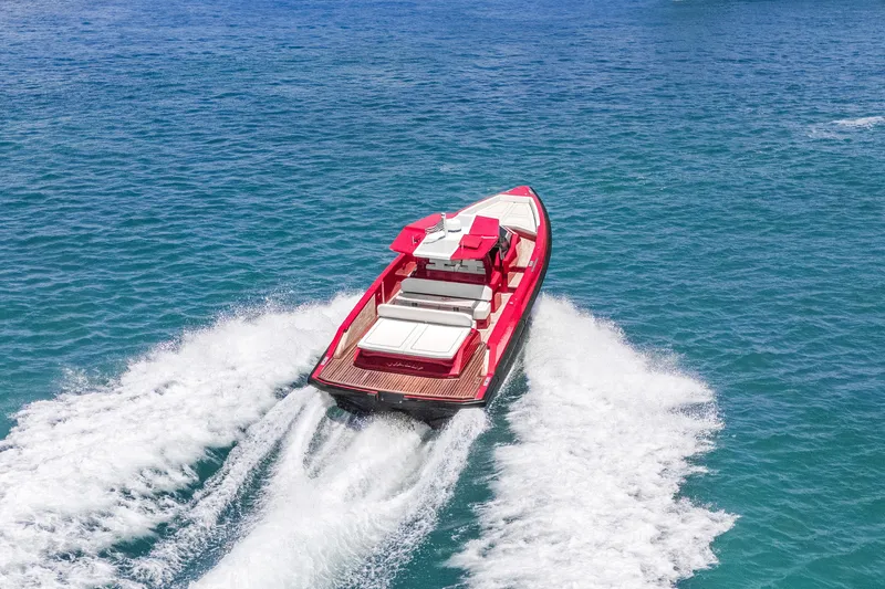 Slide: The Image of Red 2021 Wally 48 yacht cruising on clear blue ocean waters. - 12