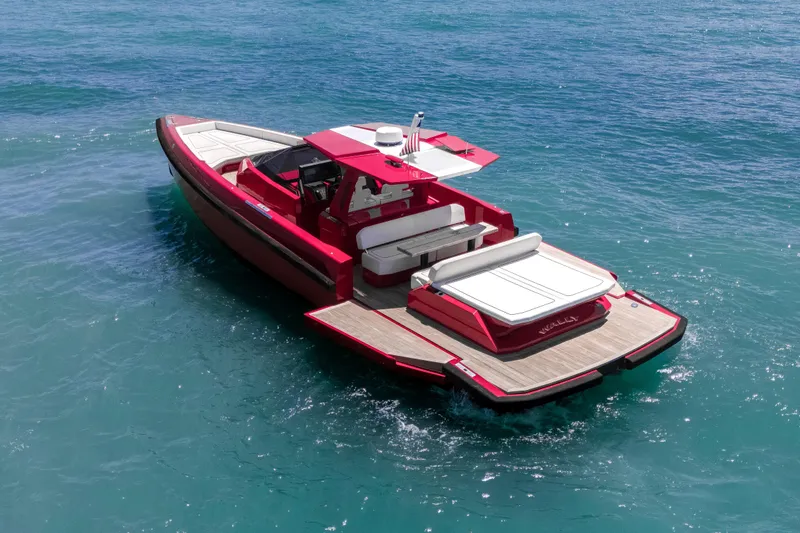 Slide: The Image of Red 2021 Wally 48 yacht cruising on clear blue water. - 16