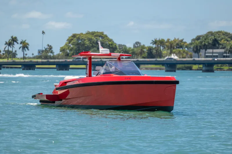 Slide: The Image of Red 2021 Wally 48 yacht cruising on a sunny day near a bridge. - 23