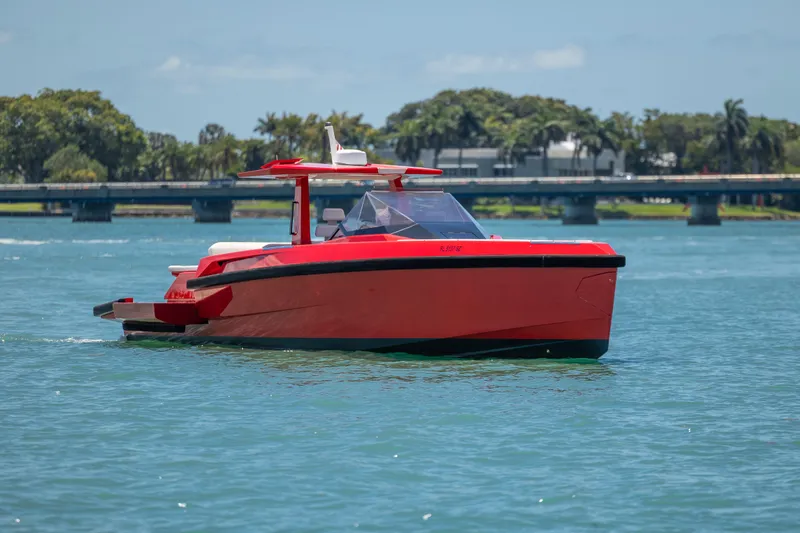 Slide: The Image of Red 2021 Wally 48 yacht cruising on a sunny day near a bridge. - 24