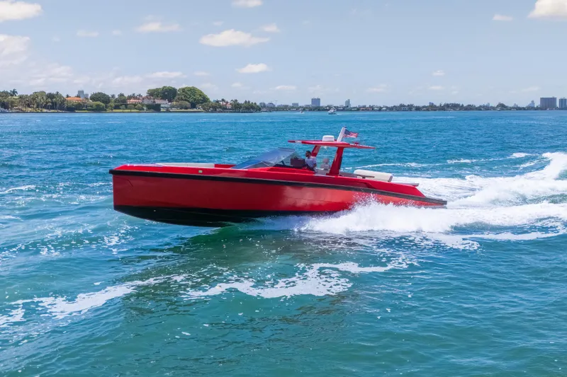 Slide: The Image of Red 2021 Wally 48 yacht cruising on blue ocean waters under a clear sky. - 3